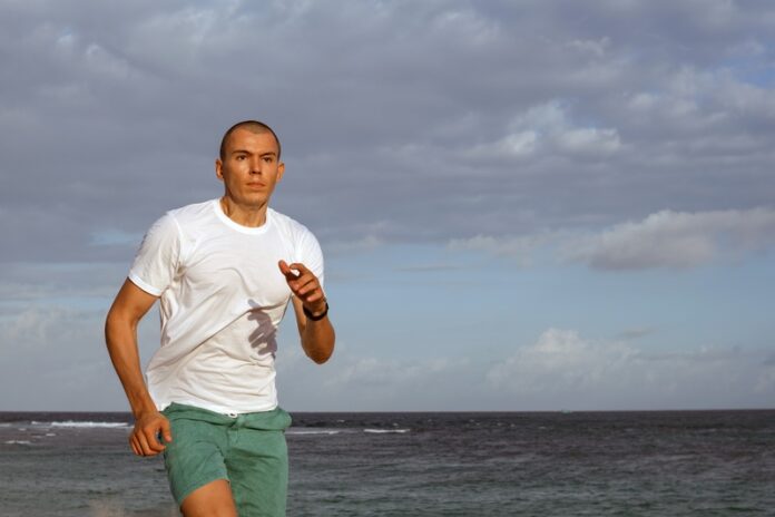 man doing sports on the beach